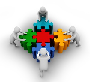 team_members_pushing_puzzle_to_build_shape_stock_photo_Slide01